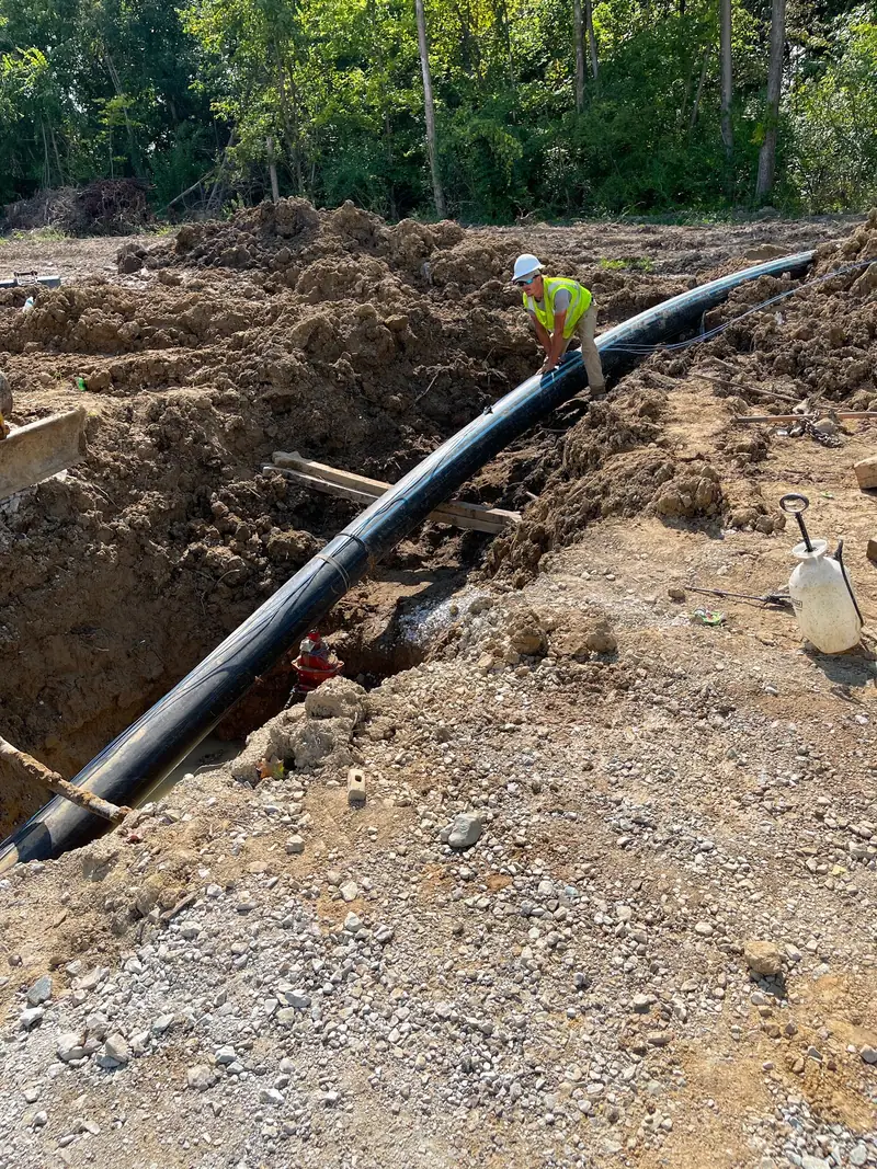 CIBC crew installing underground utility pipe
